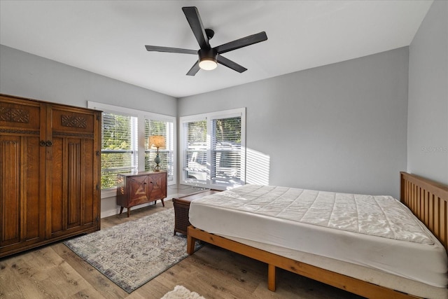 bedroom with light hardwood / wood-style floors and ceiling fan