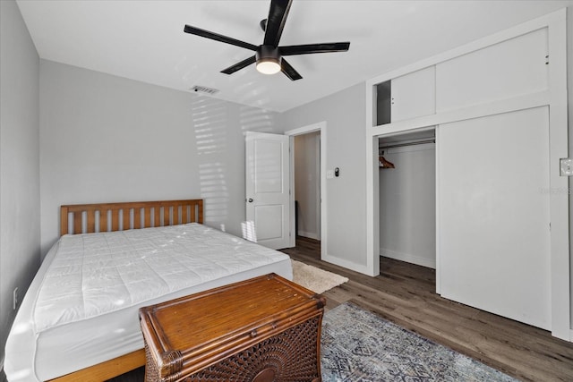 bedroom with ceiling fan, a closet, and dark hardwood / wood-style floors