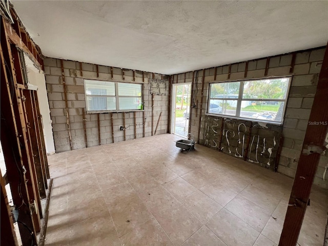 unfurnished room with a textured ceiling