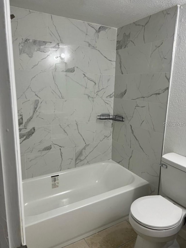 bathroom featuring shower / tub combination, toilet, and a textured ceiling