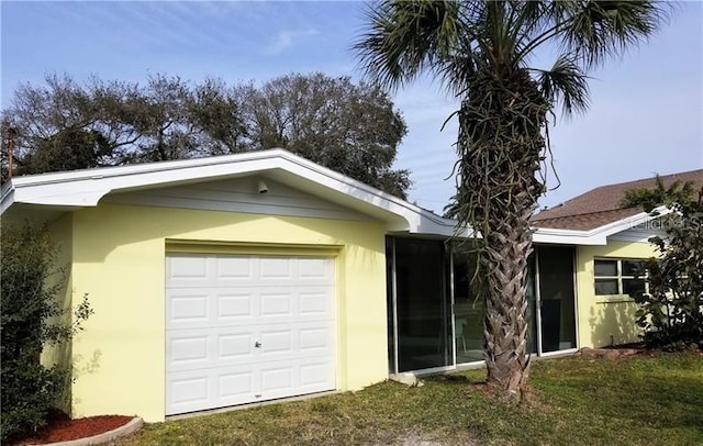 ranch-style home with a garage and a front lawn