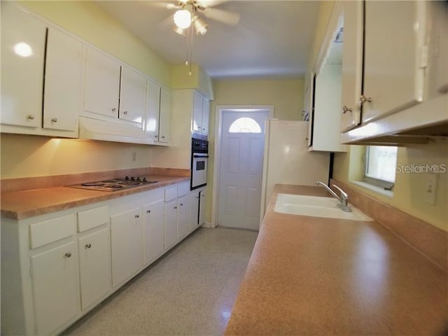 kitchen with white cabinetry, sink, ceiling fan, and white appliances