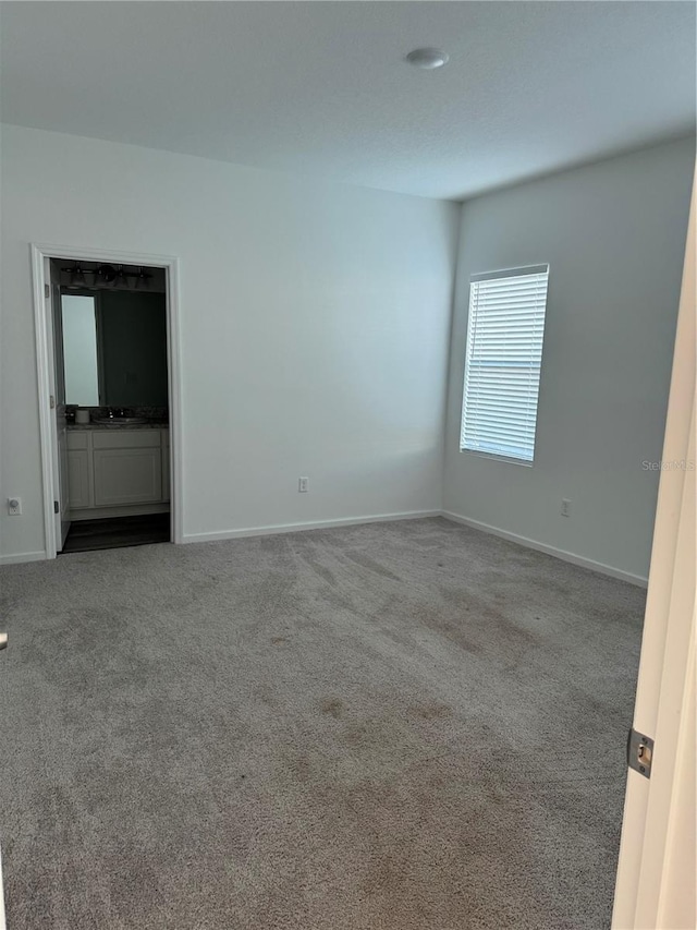 carpeted empty room with sink