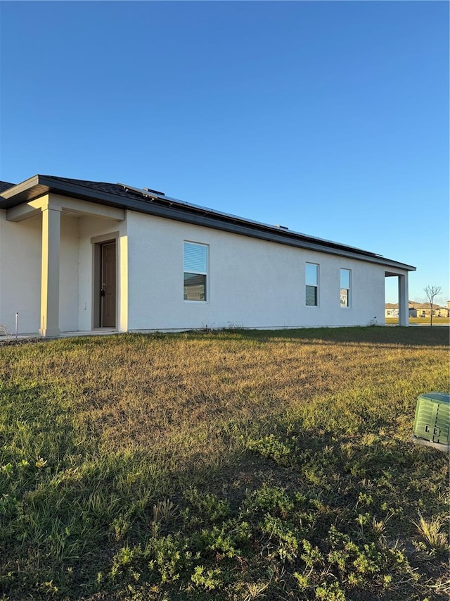 view of property exterior with a lawn