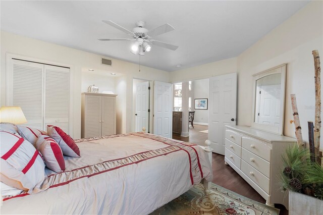 bedroom with dark hardwood / wood-style flooring, a closet, and ceiling fan