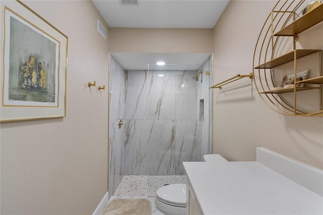 bathroom with vanity, toilet, and tiled shower