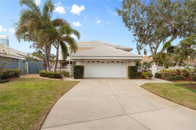 view of front of property featuring a garage and a front lawn