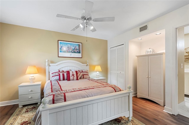 bedroom with dark hardwood / wood-style flooring, a closet, and ceiling fan