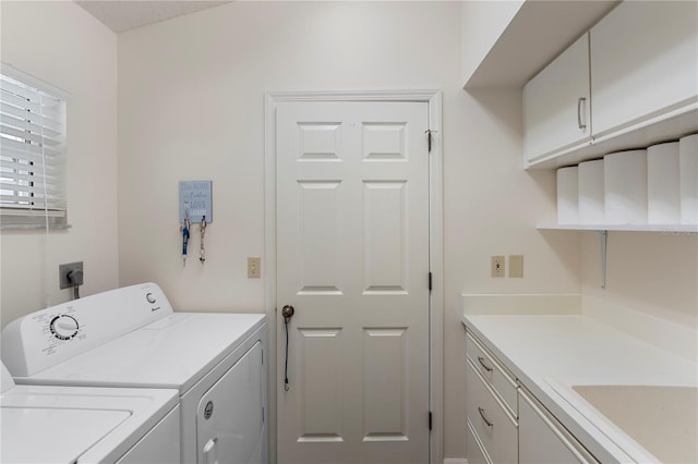 laundry room featuring cabinets, sink, and washer and clothes dryer