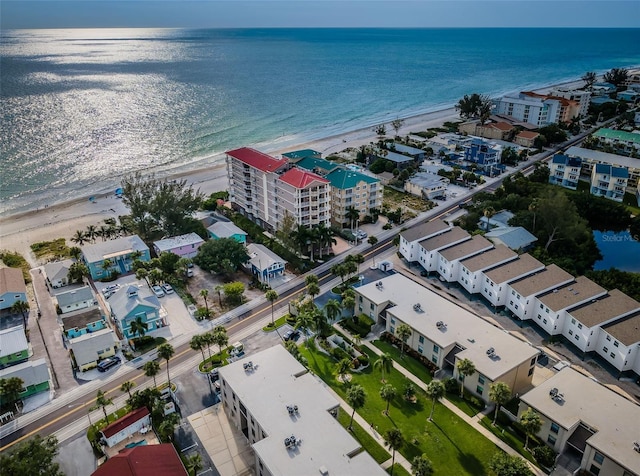 birds eye view of property featuring a water view and a beach view