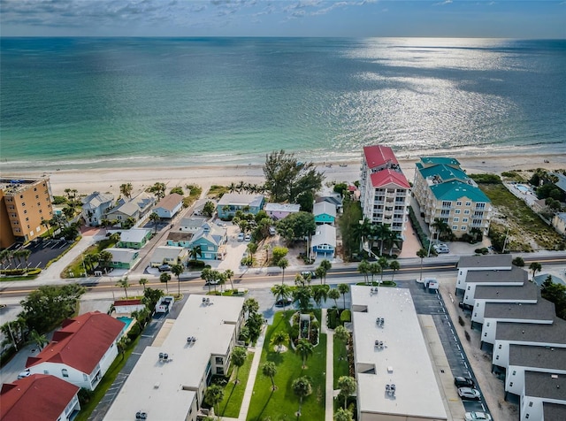 drone / aerial view with a water view and a beach view