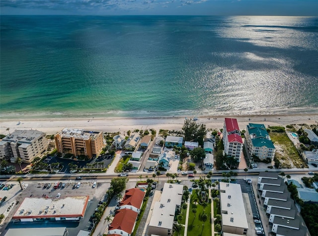 birds eye view of property with a water view and a view of the beach