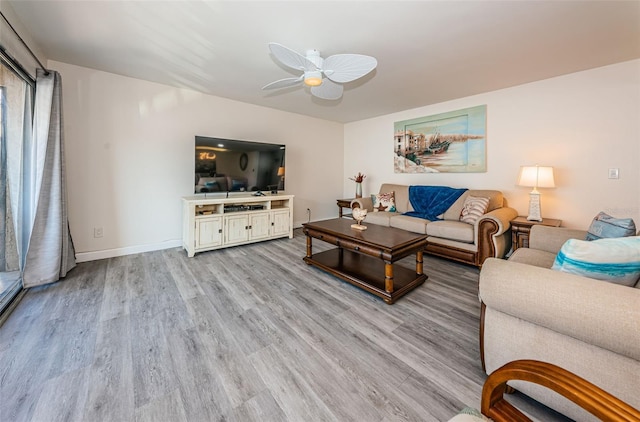 living room with ceiling fan and light hardwood / wood-style floors