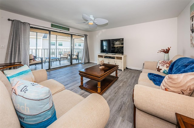 living room featuring hardwood / wood-style flooring and ceiling fan