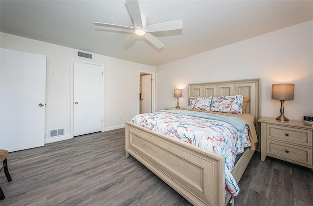 bedroom with ceiling fan and dark hardwood / wood-style floors