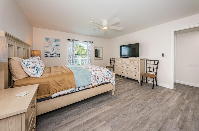 bedroom with hardwood / wood-style floors and ceiling fan