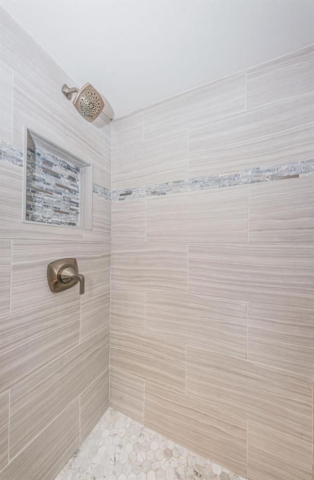 bathroom with tiled shower