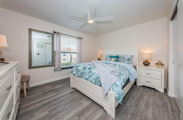 bedroom with dark hardwood / wood-style floors and ceiling fan