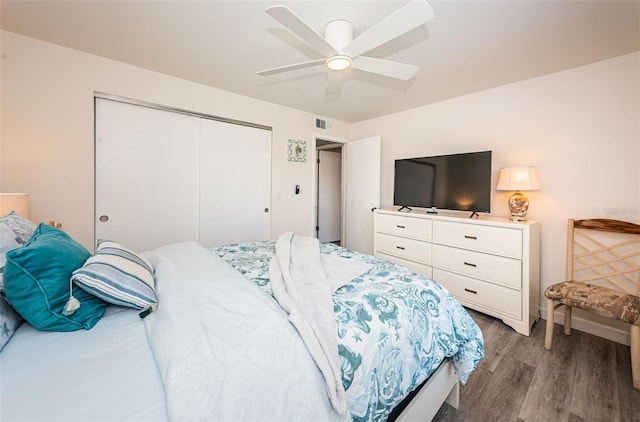 bedroom featuring a closet, hardwood / wood-style flooring, and ceiling fan