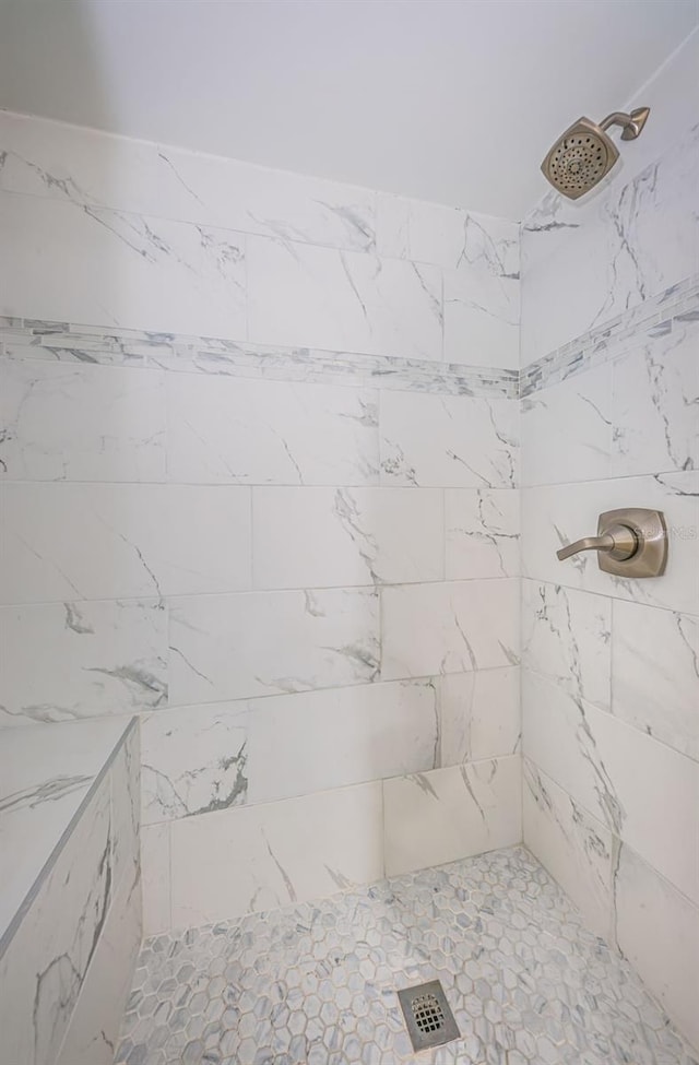 bathroom with a tile shower