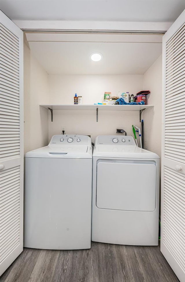 washroom featuring dark hardwood / wood-style floors and washing machine and clothes dryer