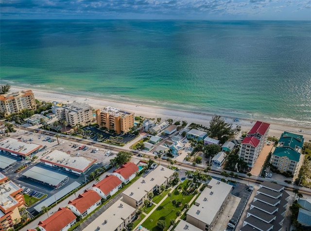 birds eye view of property with a water view and a view of the beach