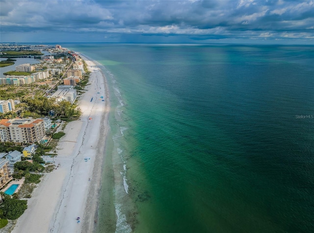 birds eye view of property with a water view and a view of the beach