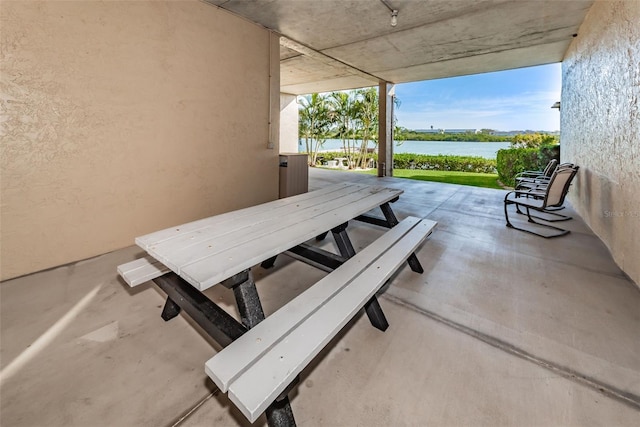 view of patio with a water view