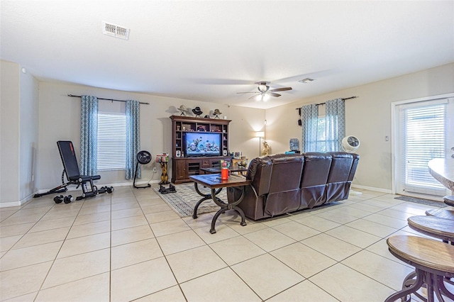 tiled living room with ceiling fan