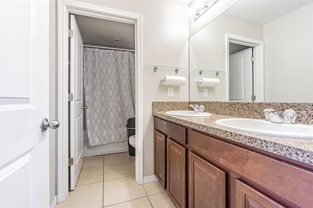 bathroom featuring toilet, vanity, and tile patterned floors