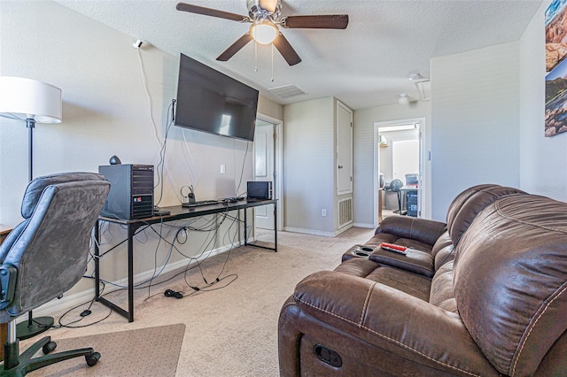 carpeted living room with ceiling fan and a textured ceiling