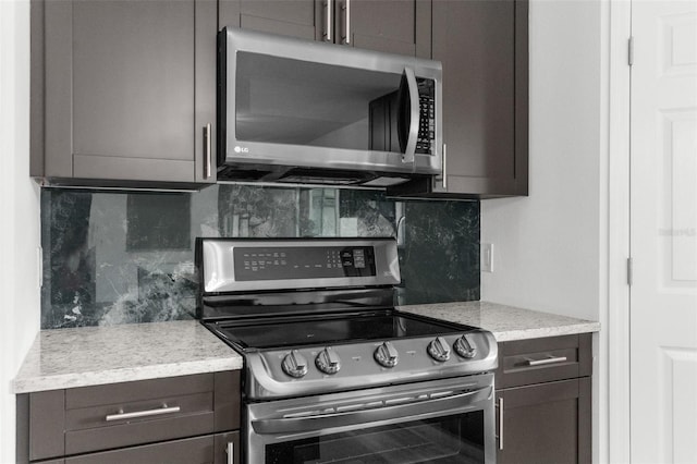 kitchen with appliances with stainless steel finishes, tasteful backsplash, and dark brown cabinets