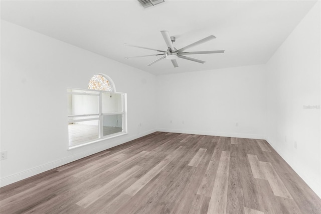 unfurnished room with ceiling fan and light wood-type flooring