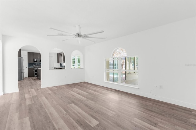 unfurnished living room with light hardwood / wood-style flooring and ceiling fan