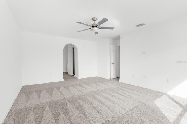 carpeted spare room featuring ceiling fan