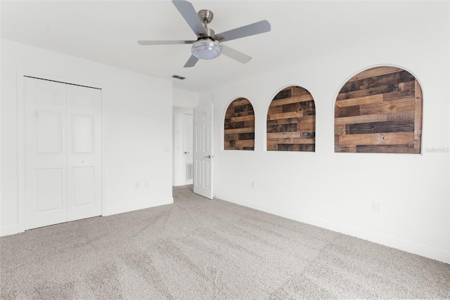 empty room featuring carpet flooring and ceiling fan