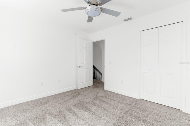 unfurnished bedroom featuring ceiling fan, carpet floors, and a closet