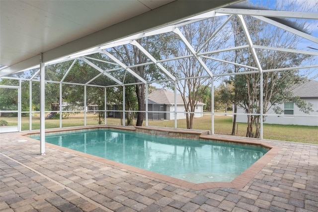 view of swimming pool featuring a lanai, a lawn, and a patio