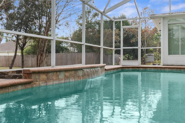 view of swimming pool featuring a lanai