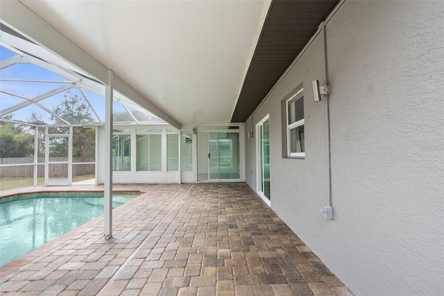 view of swimming pool with a lanai and a patio area