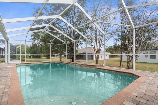 view of pool with a patio area, a lanai, and a yard