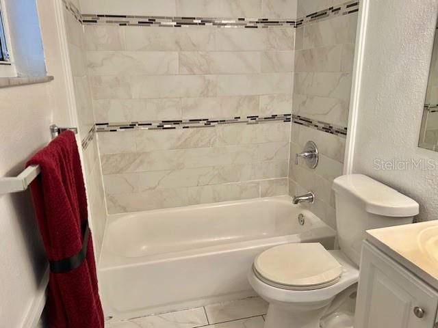 full bathroom with toilet, vanity, and tiled shower / bath combo