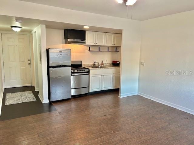 kitchen featuring dark wood-type flooring, sink, white cabinets, and appliances with stainless steel finishes