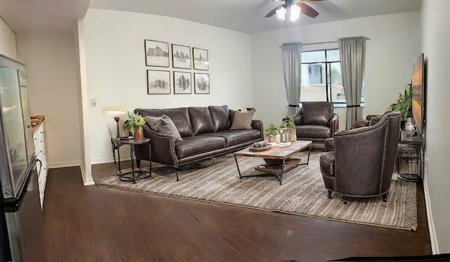 living room featuring ceiling fan and dark wood-type flooring