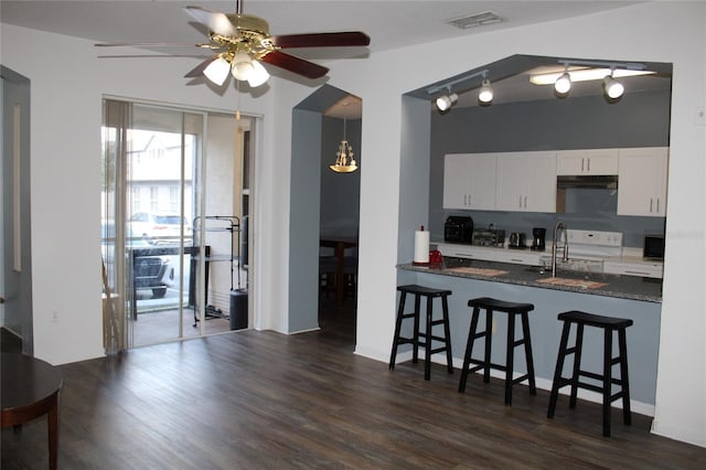 kitchen featuring dark wood-type flooring, sink, electric range, ceiling fan, and white cabinetry