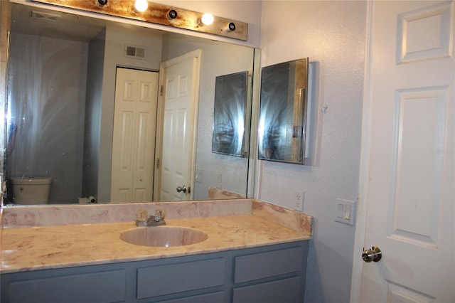 bathroom with vanity and toilet