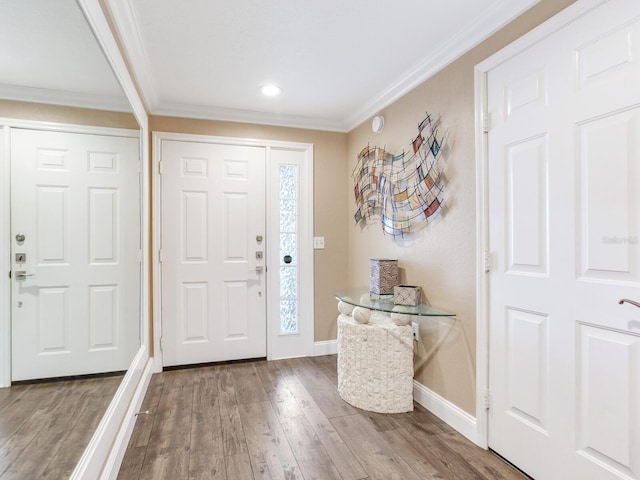 entryway with wood-type flooring and ornamental molding