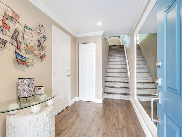 entryway with hardwood / wood-style flooring and ornamental molding