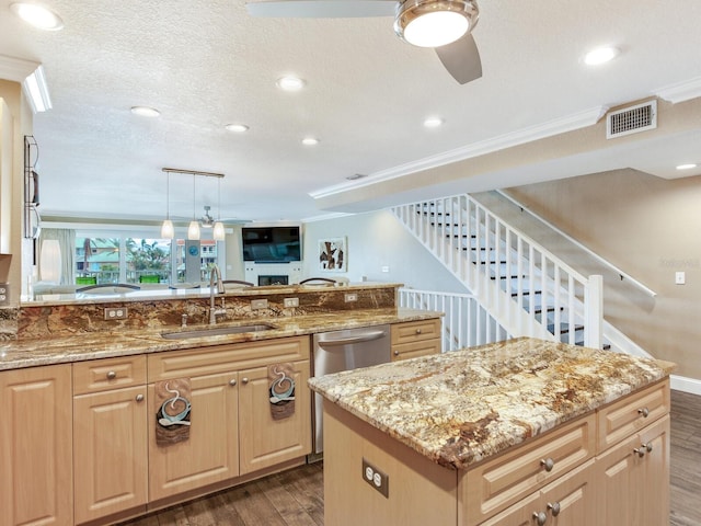 kitchen featuring a center island, sink, light stone counters, dark hardwood / wood-style floors, and pendant lighting