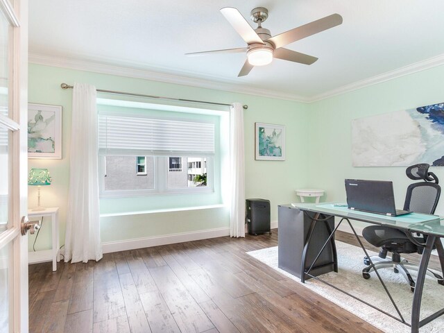 home office featuring ceiling fan, wood-type flooring, and crown molding